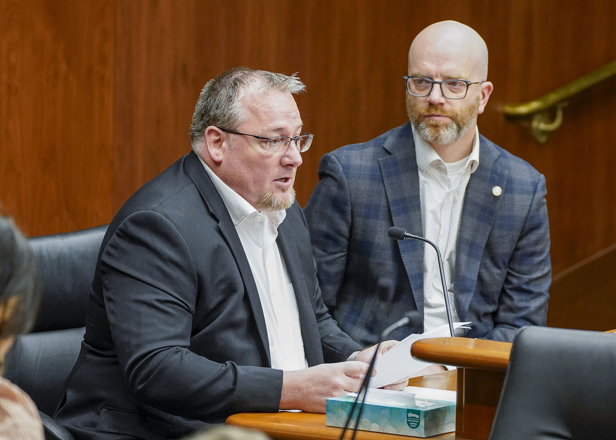 Todd Croy testifies before the House transportation committee March 26 in support of a bill sponsored by Rep. Brad Tabke, right, that would require rumble strips at locations on the trunk highway system. (Photo by Andrew VonBank)